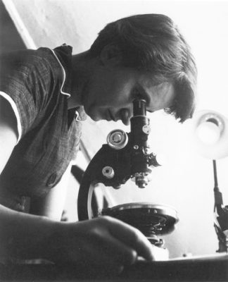 Rosalind Franklin with microscope in 1955